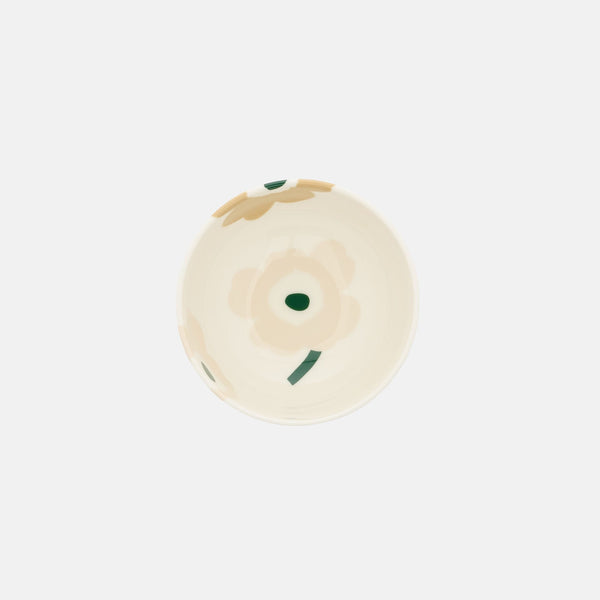 Round beige object with a green accent on a white background