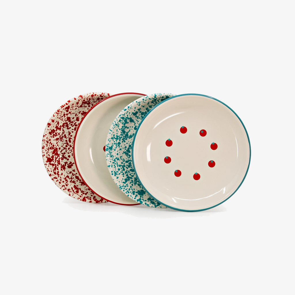 Three round ceramic plates with a speckled pattern, arranged in a fan shape on a white background. The front plate is off-white with red speckles and red dots, bordered in teal.