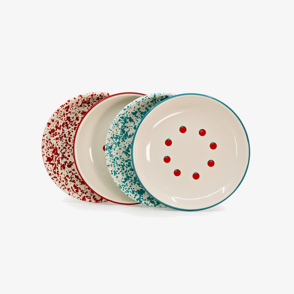 Three round ceramic plates with a speckled pattern, arranged in a fan shape on a white background. The front plate is off-white with red speckles and red dots, bordered in teal.
