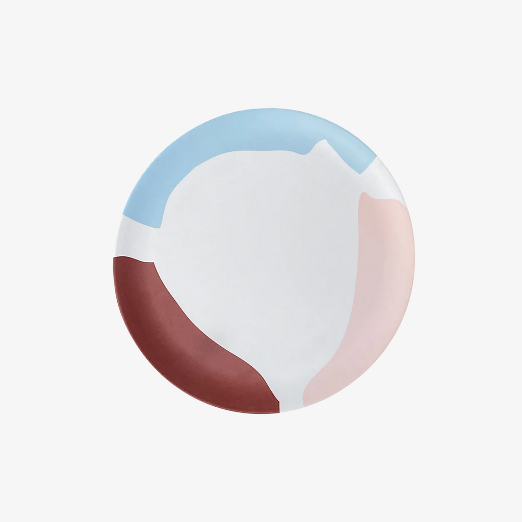 Round object with color-blocked design on a white background
