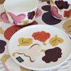 Ceramic tableware set with floral patterns on a white surface