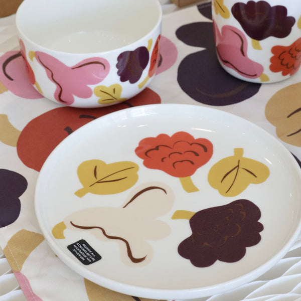 Ceramic tableware set with floral patterns on a white surface
