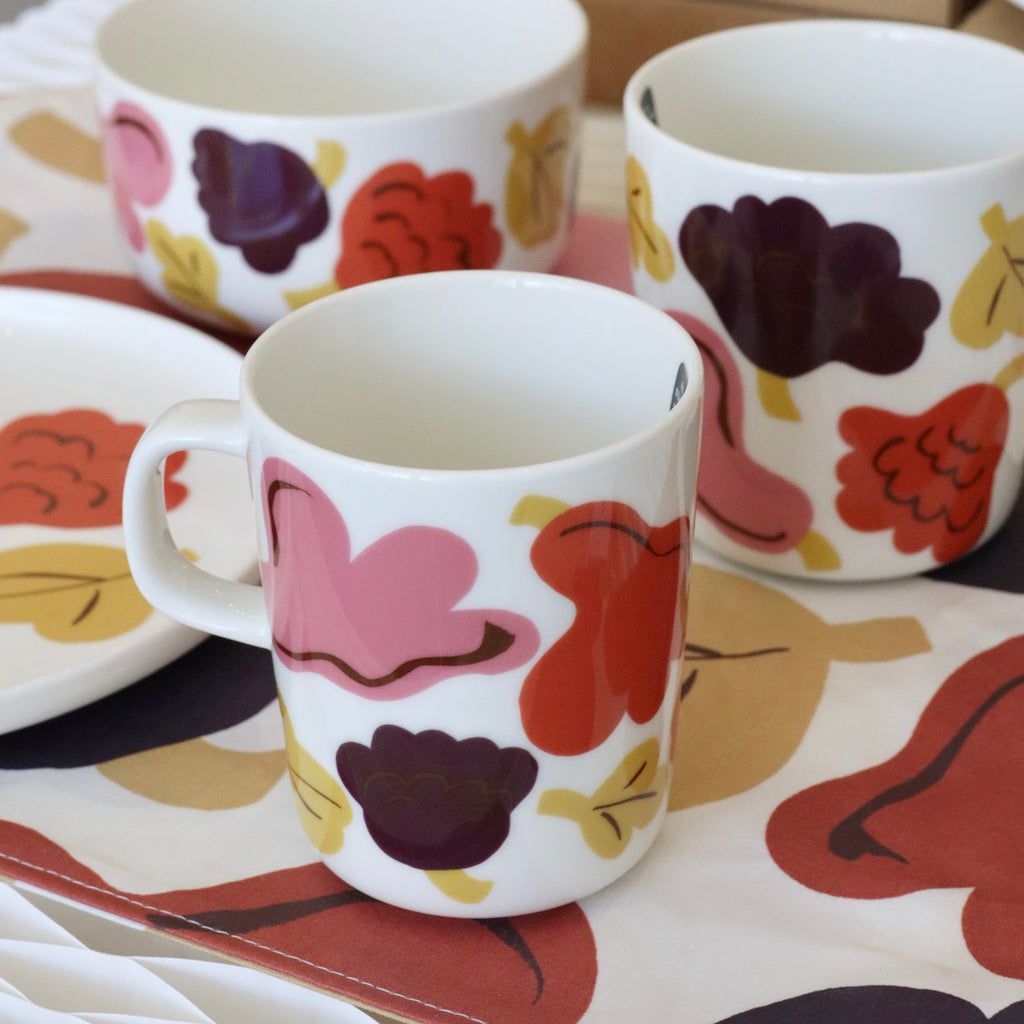 Set of floral-patterned mugs on a table