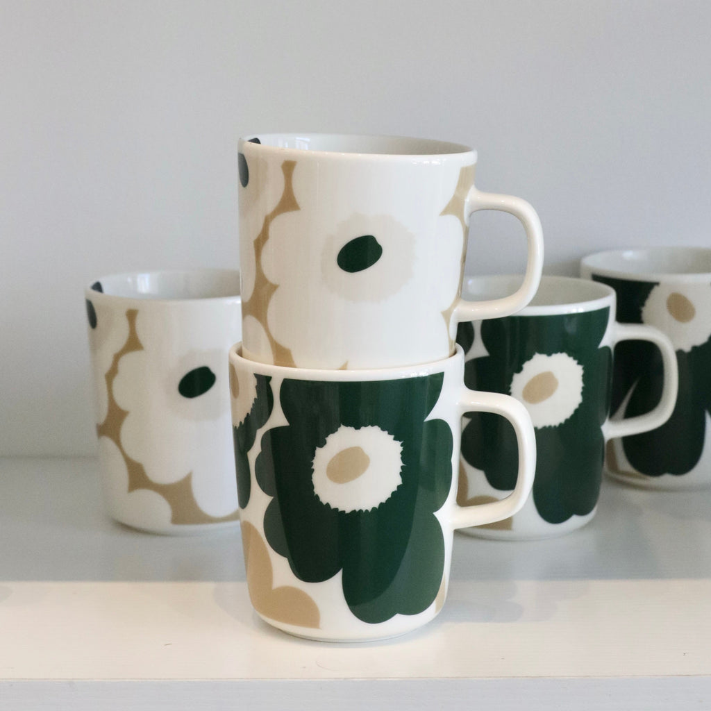 Set of ceramic mugs with floral pattern on a white surface