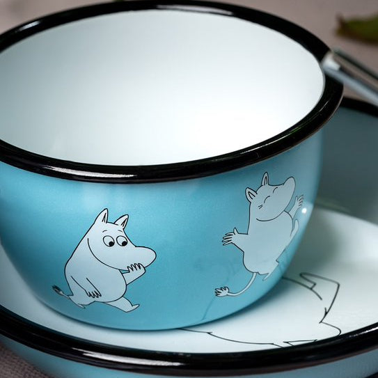 Blue ceramic bowl with white illustrations of cartoon characters on a matching plate.