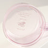 Pink lid with text and branding on a white background