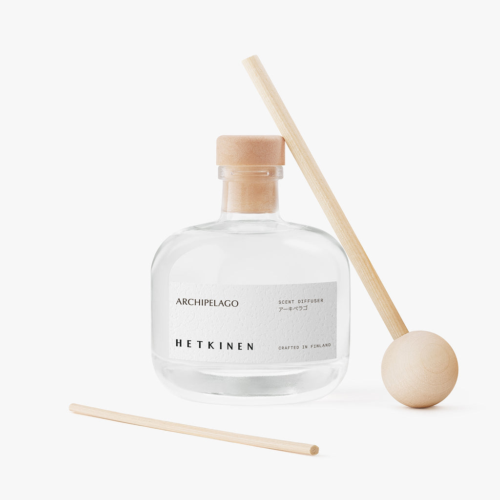 Clear diffuser bottle with wooden sticks on a white background